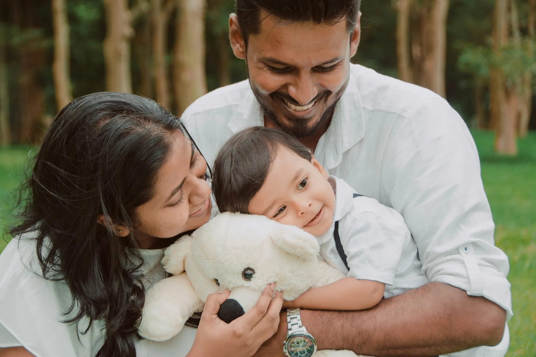 Parents holding their young child outdoors